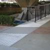 Stainless steel floor plate bridge cut on radius to match circular pathway.